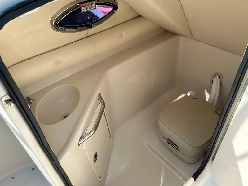 Slide: The Image of 2007 Sea Ray 240 Sundeck interior with sink and portable toilet. - 10