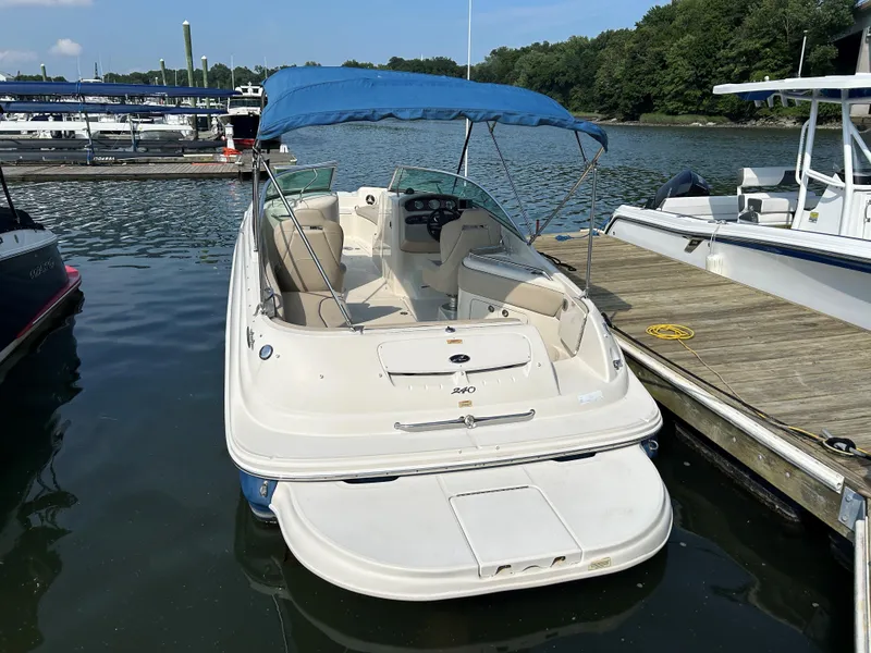 Slide: The Image of 2007 Sea Ray 240 Sundeck boat docked with blue canopy. - 3