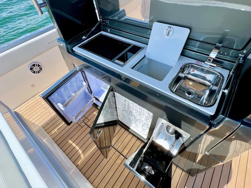 Slide: The Image of Outdoor kitchen on 2025 Schaefer V33 yacht with sink, grill, and refrigerator. - 11