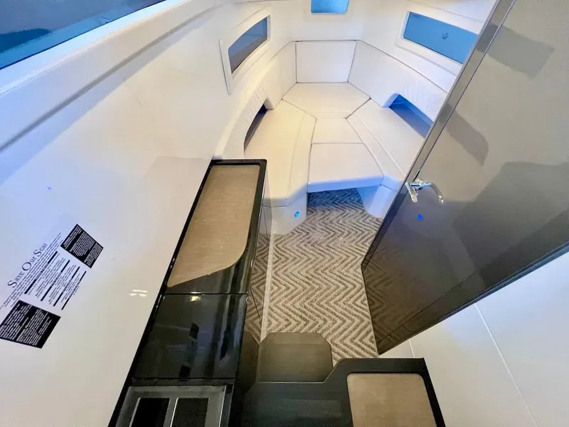 Slide: The Image of Interior cabin of 2025 Schaefer V33 boat with modern seating and sleek design. - 18