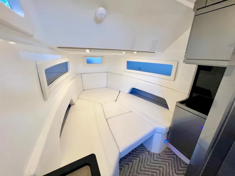 Slide: The Image of Modern interior of 2025 Schaefer V33 boat with white seating and windows. - 20