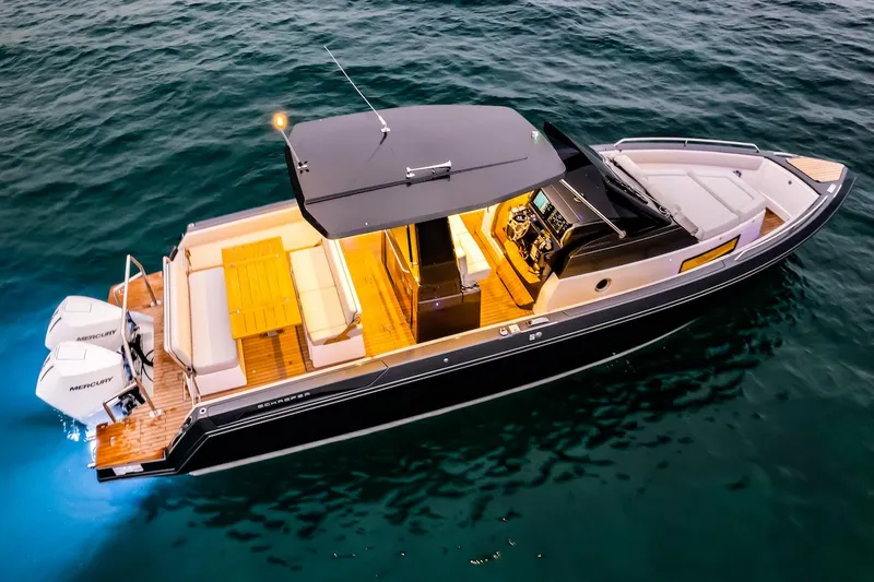 Slide: The Image of Schaefer V33 2025 luxury motorboat with twin Mercury engines, illuminated deck, and modern design. - 29