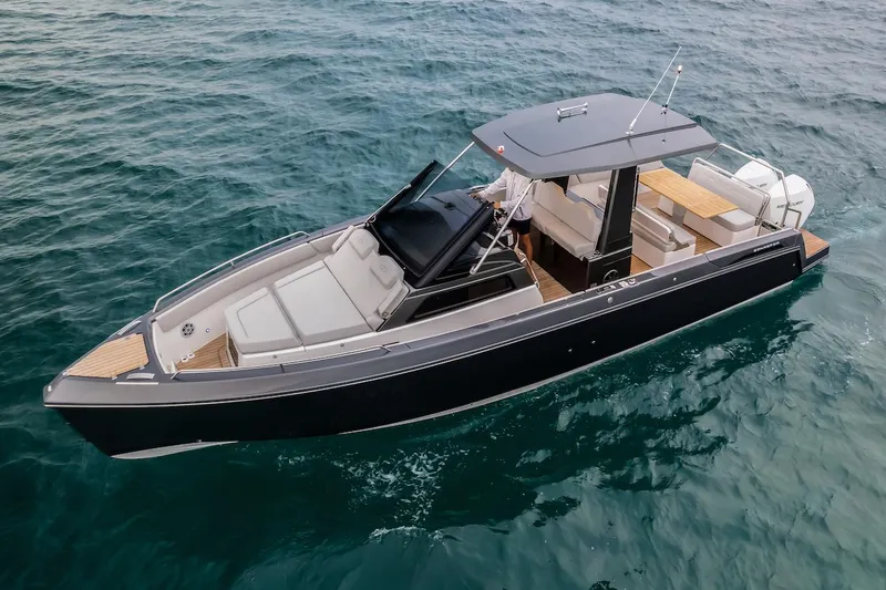 Slide: The Image of 2025 Schaefer V33 luxury motorboat cruising on open water. - 1