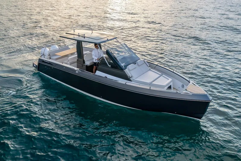 Slide: The Image of 2025 Schaefer V33 boat cruising on open water. - 2