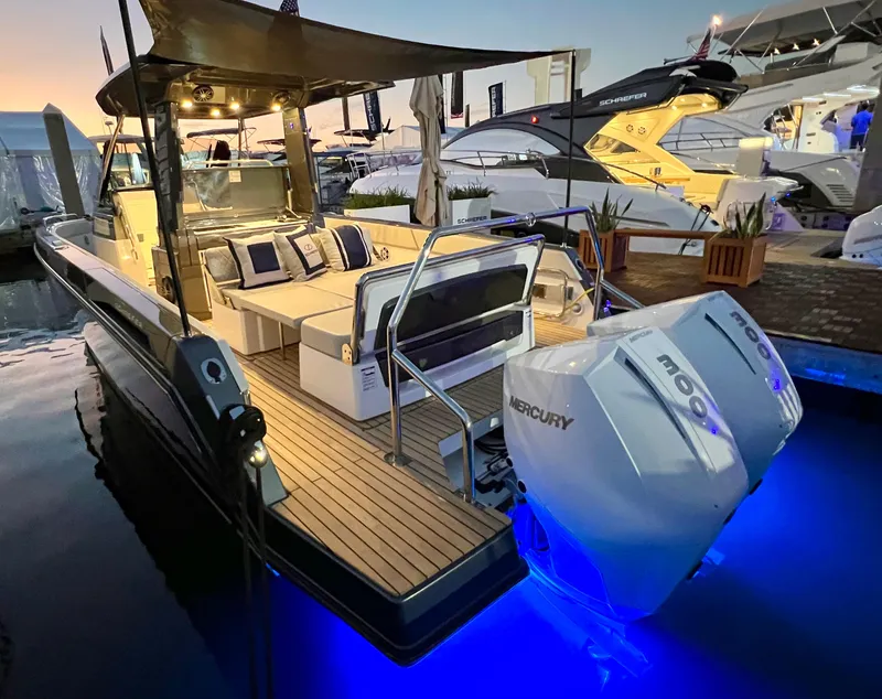 Slide: The Image of 2025 Schaefer V33 boat with twin Mercury 300 engines docked at sunset. - 35