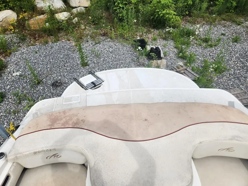 Slide: The Image of 2007 Monterey 180 FS boat interior with beige seating and outdoor surroundings. - 4