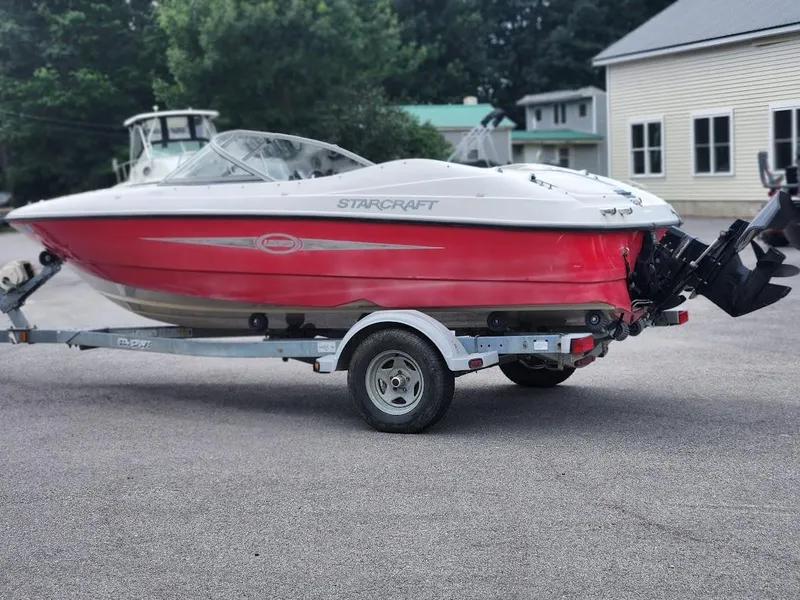 Slide: The Image of 2007 Starcraft 1700 Limited boat on a trailer, red and white exterior. - 3