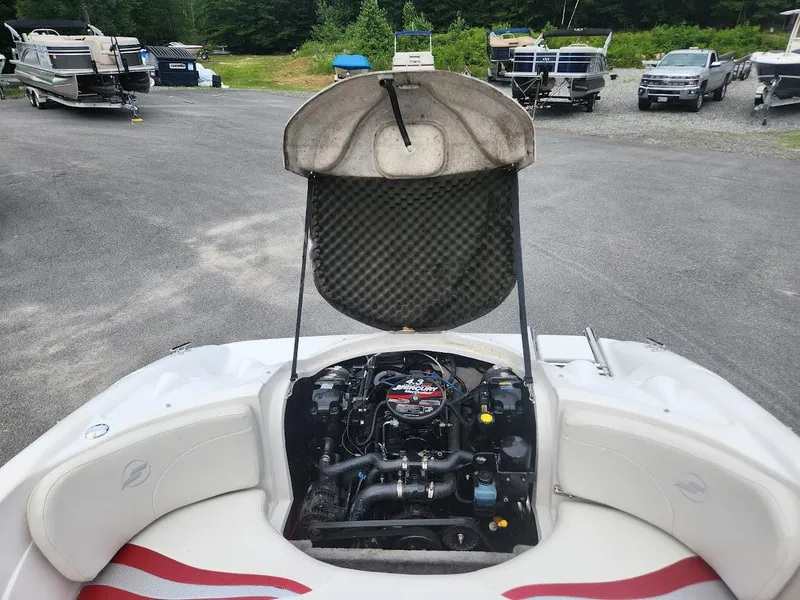 Slide: The Image of 2007 Starcraft 1700 Limited boat engine compartment open in a marina. - 7