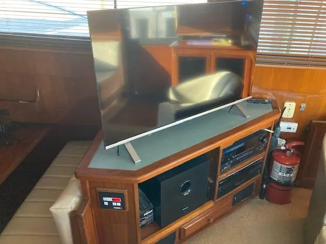 Slide: The Image of Flat-screen TV on wooden entertainment center in 1987 Viking Convertible yacht. - 11
