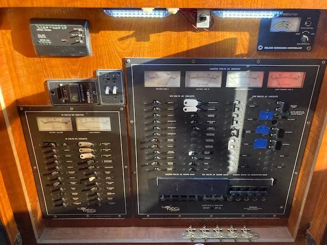 Slide: The Image of 1987 Viking Convertible boat control panel with various switches and gauges. - 12