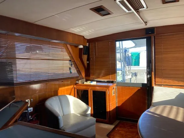 Slide: The Image of 1987 Viking Convertible yacht interior with wooden paneling and white chair. - 13
