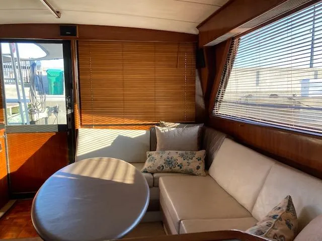 Slide: The Image of Interior of 1987 Viking Convertible yacht with beige seating and wooden blinds. - 14