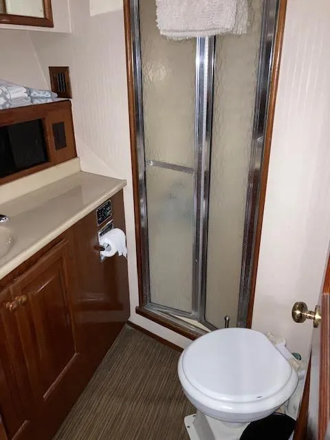 Slide: The Image of 1987 Viking Convertible bathroom with shower, sink, and toilet. - 18