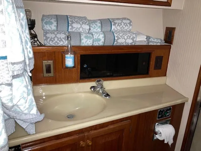 Slide: The Image of 1987 Viking Convertible bathroom sink with wooden cabinetry and neatly folded towels. - 19