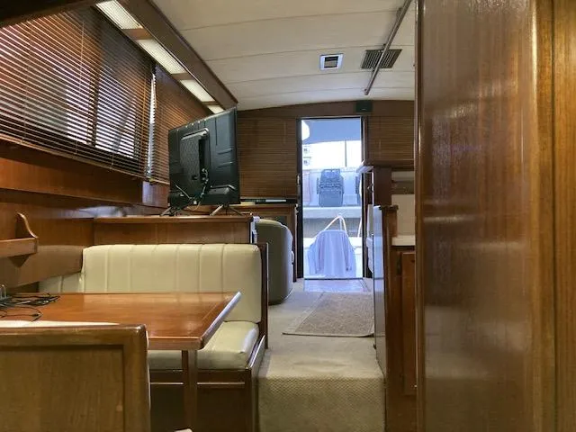Slide: The Image of Interior of 1987 Viking Convertible yacht with wooden furnishings and dining area. - 21