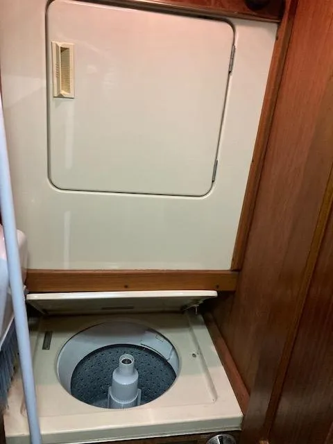 Slide: The Image of 1987 Viking Convertible boat interior with built-in washing machine. - 22