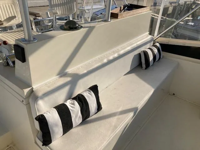 Slide: The Image of 1987 Viking Convertible boat interior with striped cushions and seating area. - 3