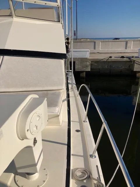 Slide: The Image of 1987 Viking Convertible yacht docked at marina, side deck view. - 6