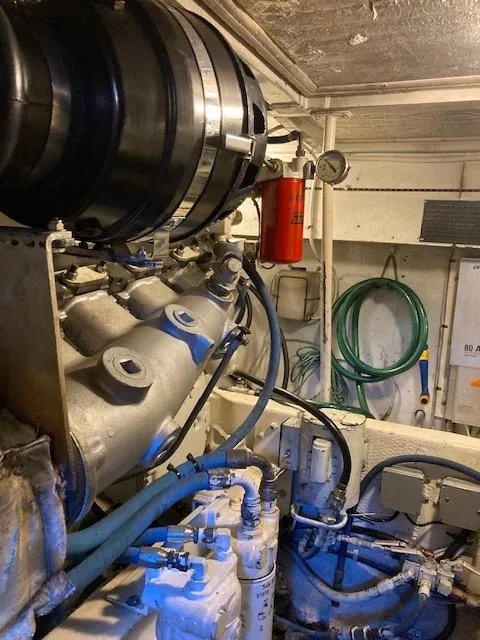 Slide: The Image of Engine room of a 1987 Viking Convertible boat with hoses and machinery. - 8