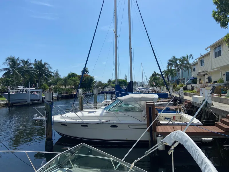 Slide: The Image of 1992 Tiara Yachts 31 Open docked in a sunny marina with palm trees. - 1