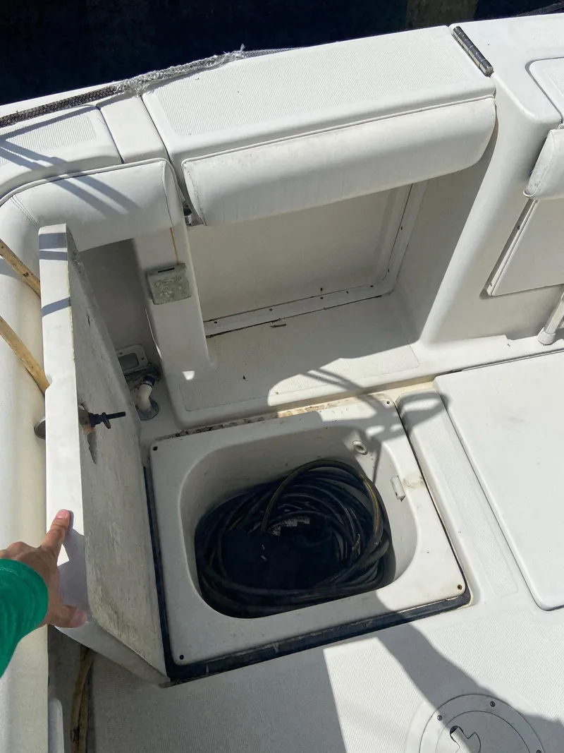 Slide: The Image of 1992 Tiara Yachts 31 Open deck storage compartment with coiled cables. - 13