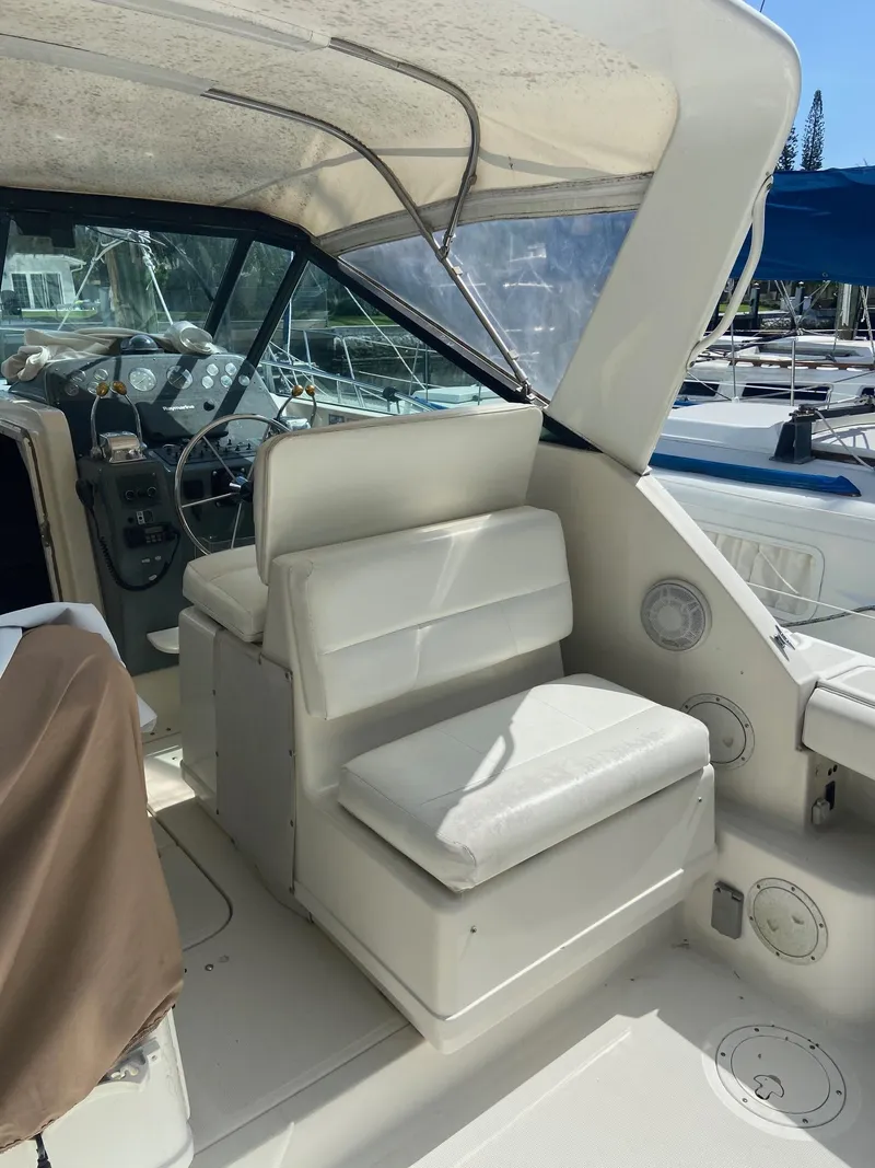 Slide: The Image of 1992 Tiara Yachts 31 Open cockpit with white seating and helm station. - 14