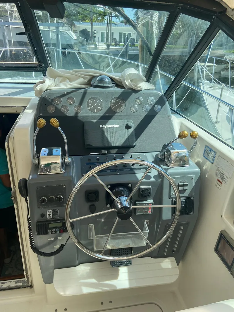 Slide: The Image of 1992 Tiara Yachts 31 Open helm with steering wheel and navigation controls. - 15