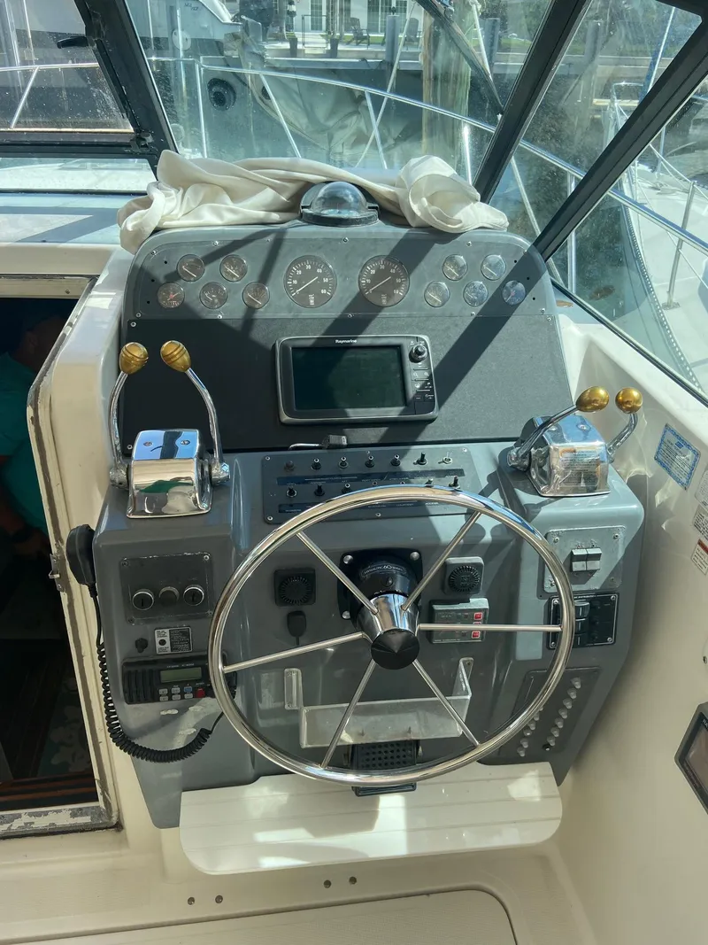 Slide: The Image of 1992 Tiara Yachts 31 Open helm station with steering wheel and control panel. - 16