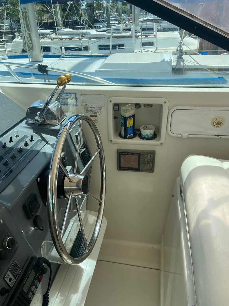 Slide: The Image of 1992 Tiara Yachts 31 Open helm with steering wheel and control panel. - 17