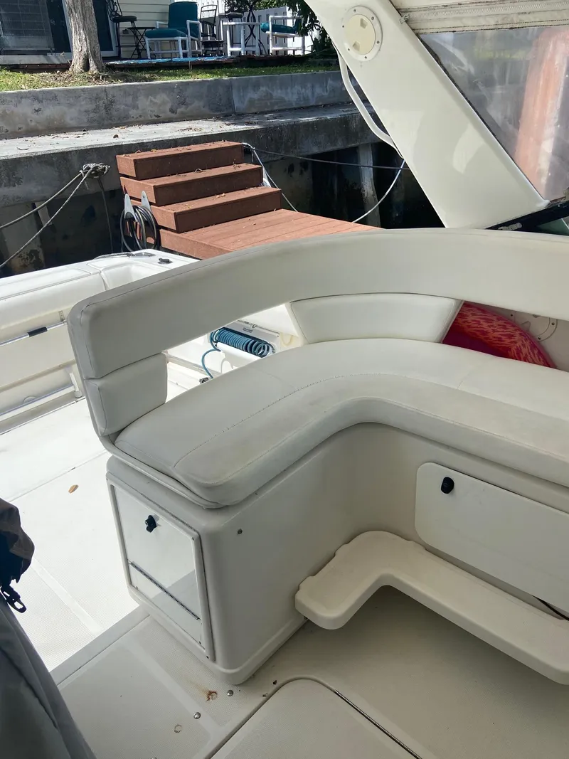 Slide: The Image of 1992 Tiara Yachts 31 Open boat interior with white seating and storage compartments. - 18