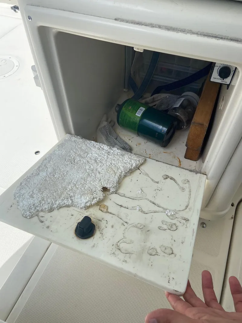 Slide: The Image of 1992 Tiara Yachts 31 Open storage compartment with equipment and insulation. - 21