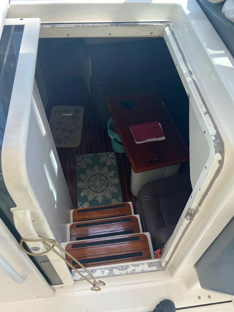 Slide: The Image of 1992 Tiara Yachts 31 Open cabin interior with wooden steps and table. - 22