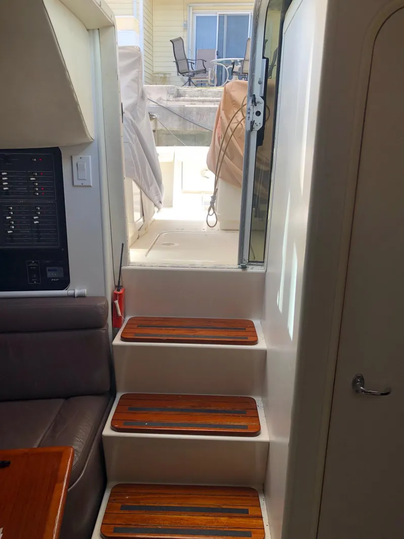 Slide: The Image of Interior stairs of a 1992 Tiara Yachts 31 Open leading to the deck. - 23