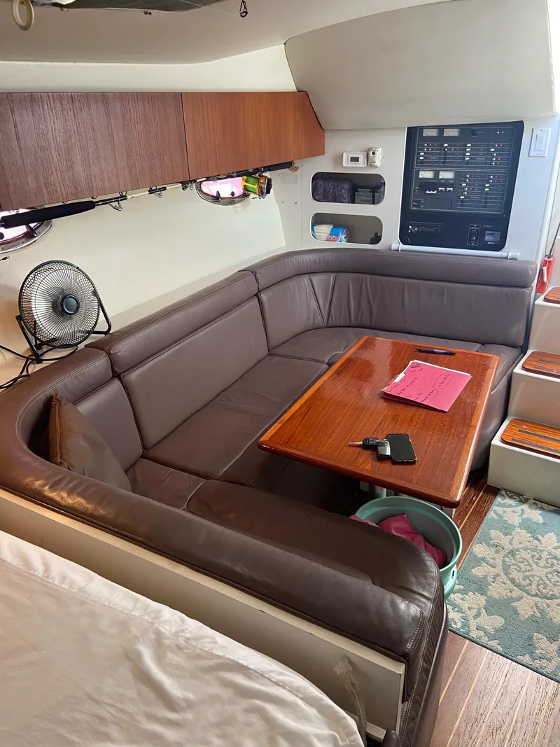 Slide: The Image of 1992 Tiara Yachts 31 Open cabin interior with leather seating and wooden table. - 27
