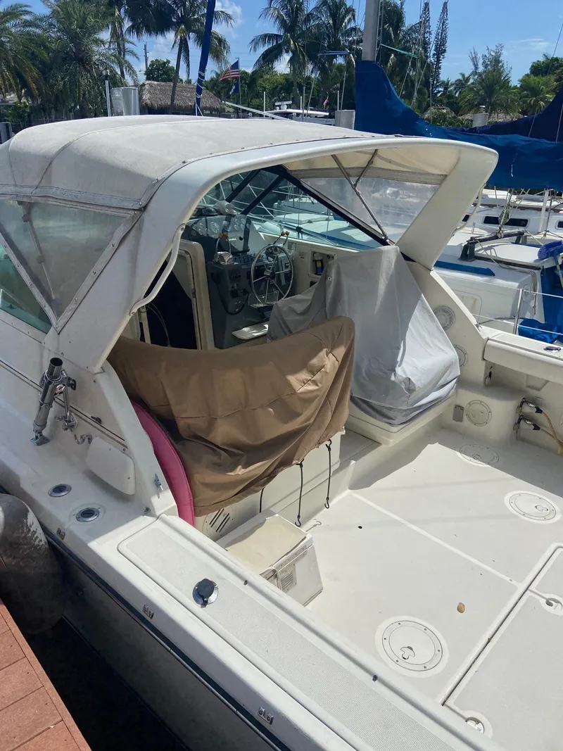 Slide: The Image of 1992 Tiara Yachts 31 Open docked, featuring a spacious cockpit and covered helm. - 3