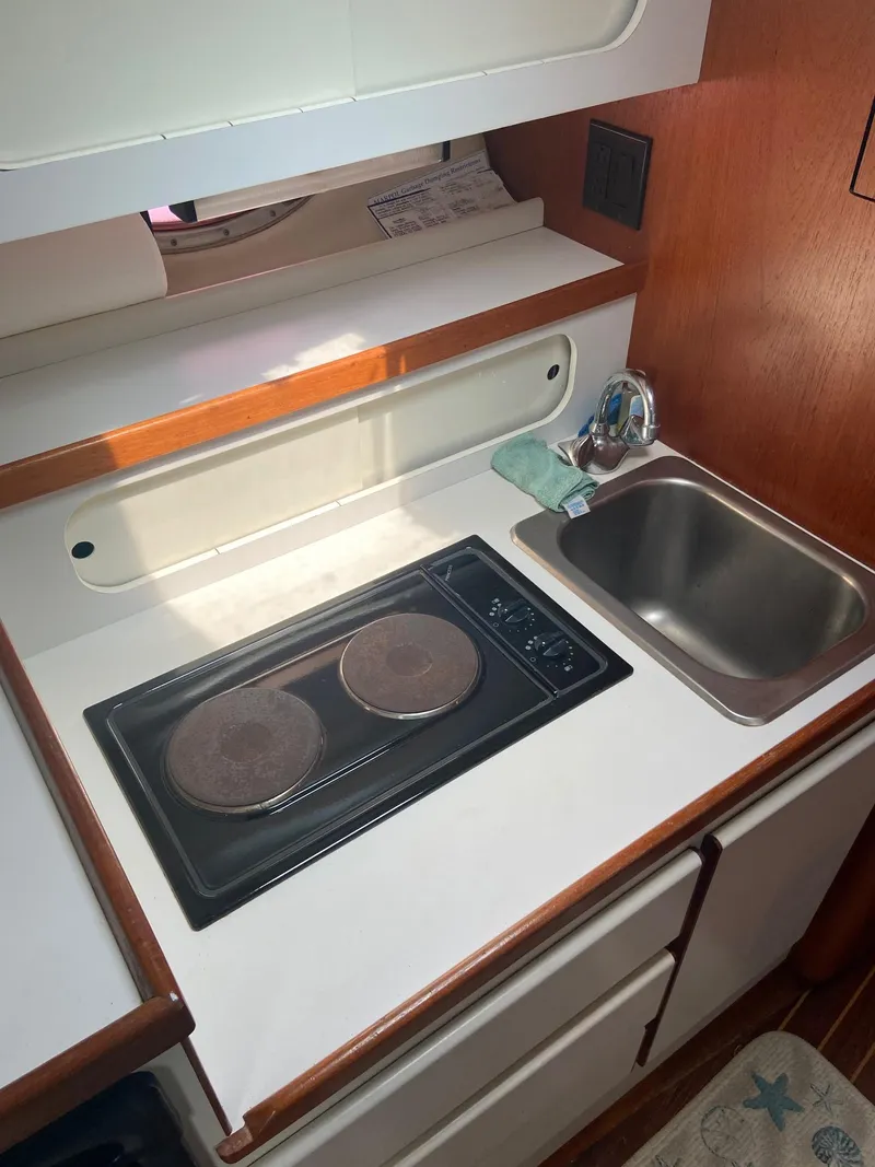 Slide: The Image of 1992 Tiara Yachts 31 Open galley with stove and sink. - 30