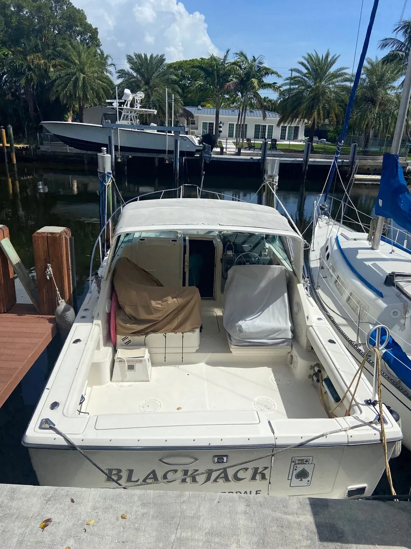 Slide: The Image of 1992 Tiara Yachts 31 Open docked, rear view with covered seating. - 4