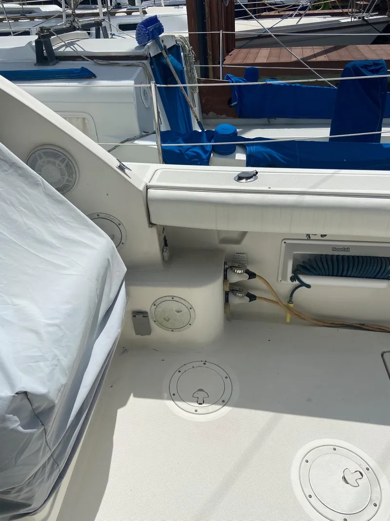 Slide: The Image of 1992 Tiara Yachts 31 Open boat deck with covered seating and storage compartments. - 8