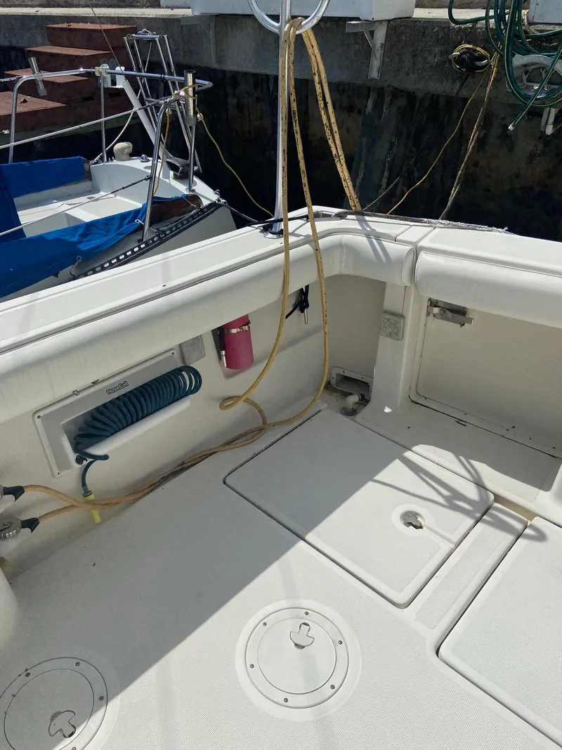 Slide: The Image of 1992 Tiara Yachts 31 Open boat deck with storage compartments and coiled hose. - 9