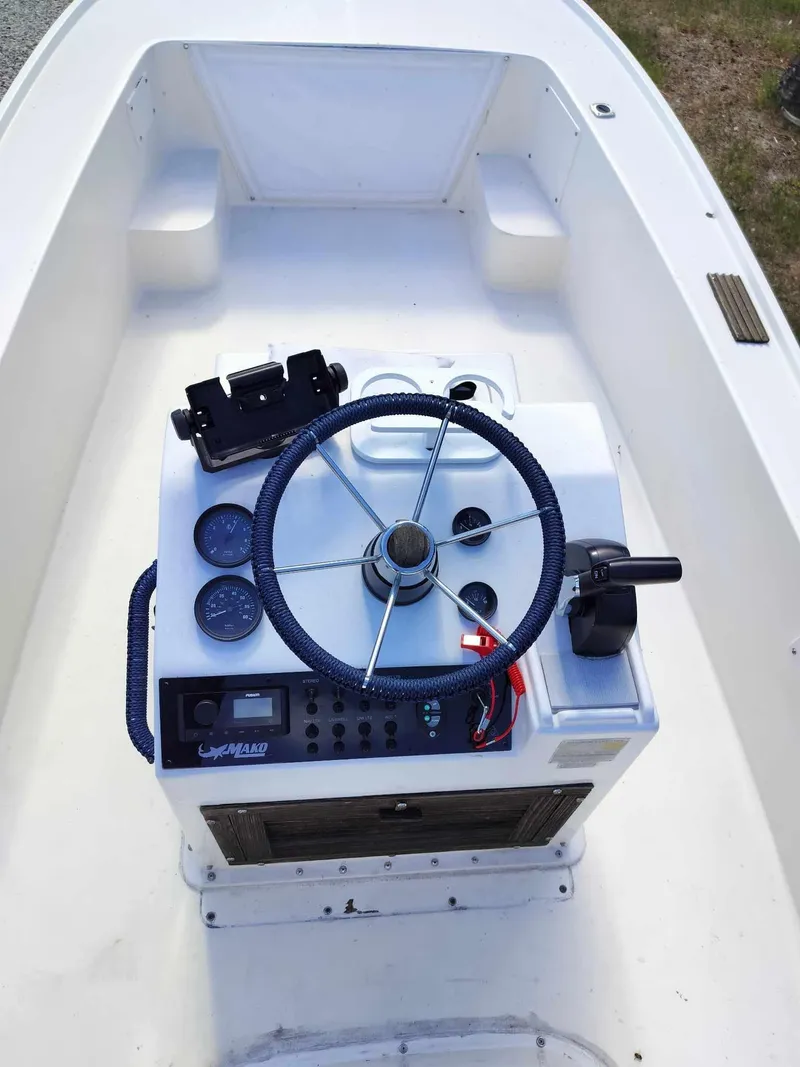 Slide: The Image of 1988 Mako 171 Center Console boat dashboard with steering wheel and controls. - 11