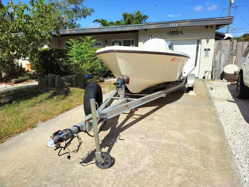 Slide: The Image of 1988 Mako 171 Center Console boat on trailer in driveway. - 13