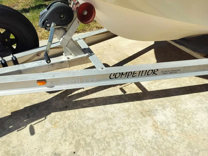 Slide: The Image of 1988 Mako 171 Center Console boat on a trailer labeled Competitor. - 14