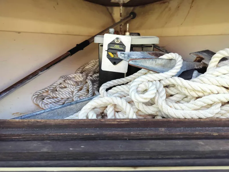 Slide: The Image of Storage compartment of a 1988 Mako 171 Center Console with anchor and ropes. - 15