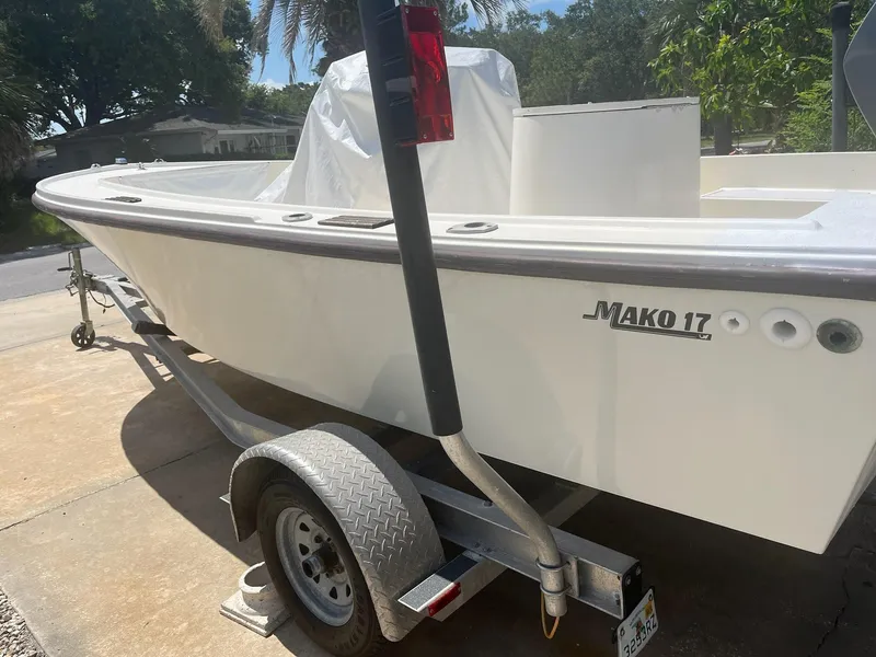 Slide: The Image of 1988 Mako 171 Center Console boat on trailer in driveway. - 21