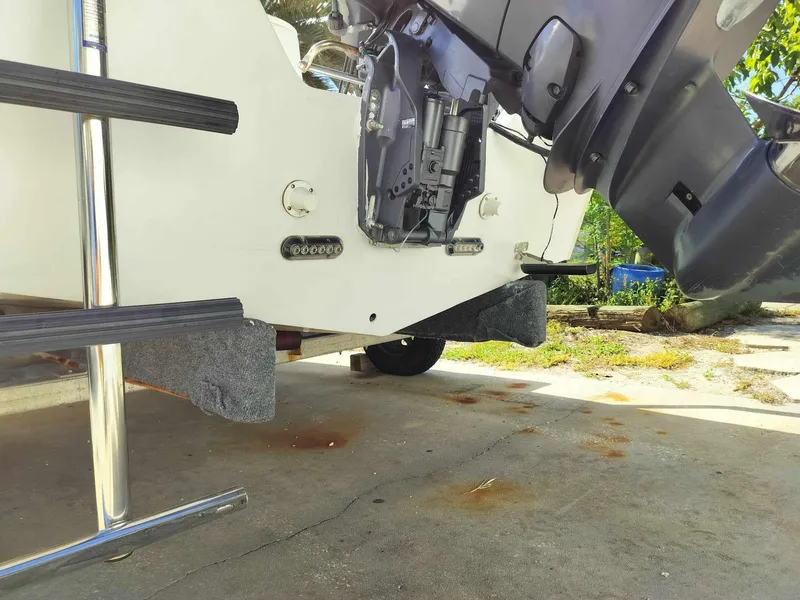 Slide: The Image of 1988 Mako 171 Center Console boat with outboard motor and ladder. - 24