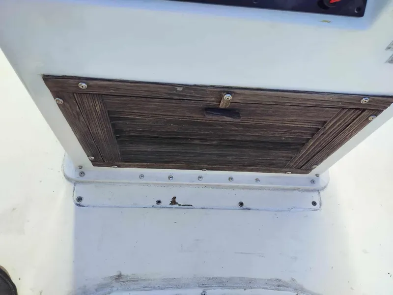 Slide: The Image of 1988 Mako 171 Center Console wooden storage compartment. - 25