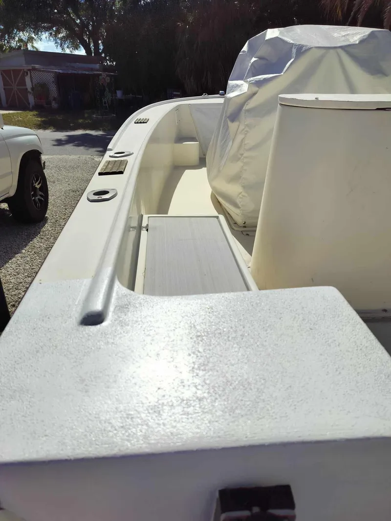 Slide: The Image of 1988 Mako 171 Center Console boat interior with covered console and seating. - 26
