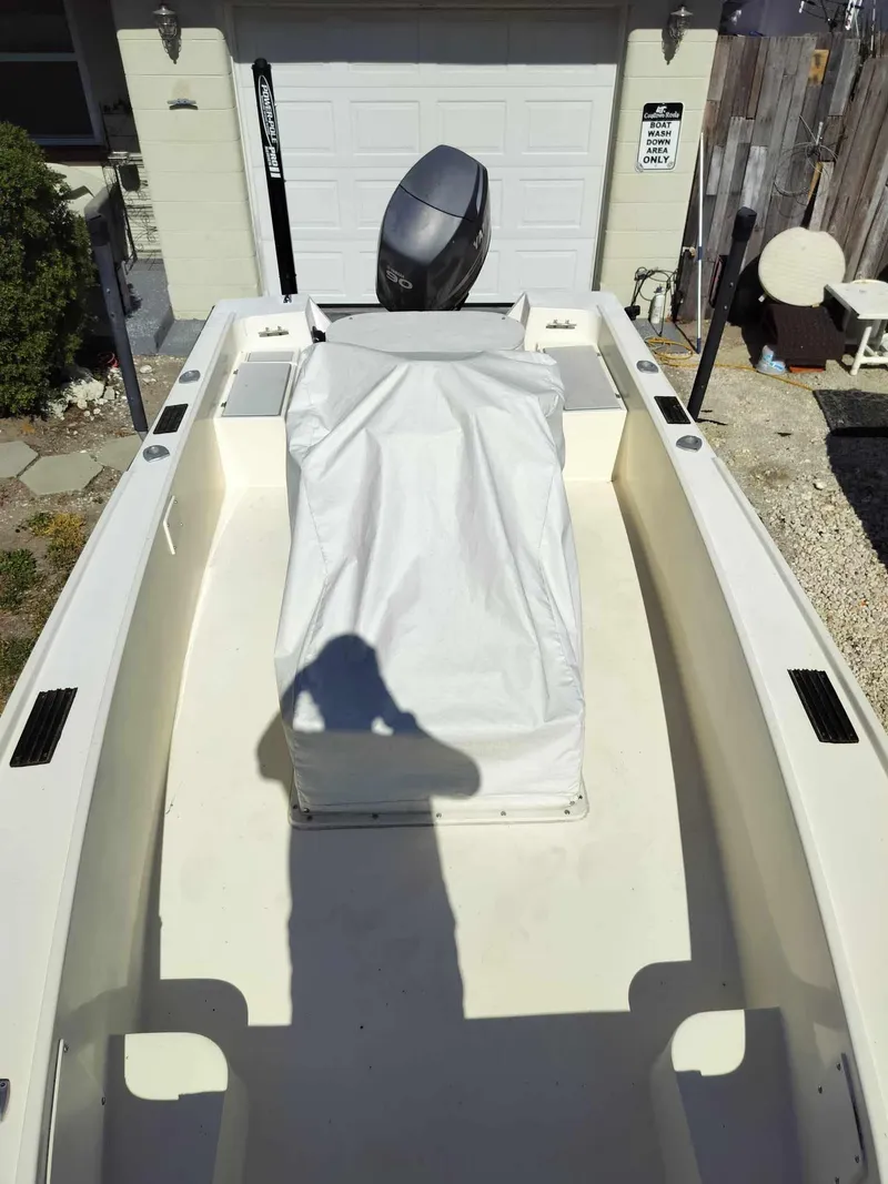 Slide: The Image of 1988 Mako 171 Center Console boat with covered console and outboard motor. - 28