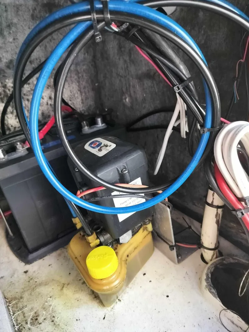 Slide: The Image of 1988 Mako 171 Center Console boat engine compartment with wiring and battery. - 33