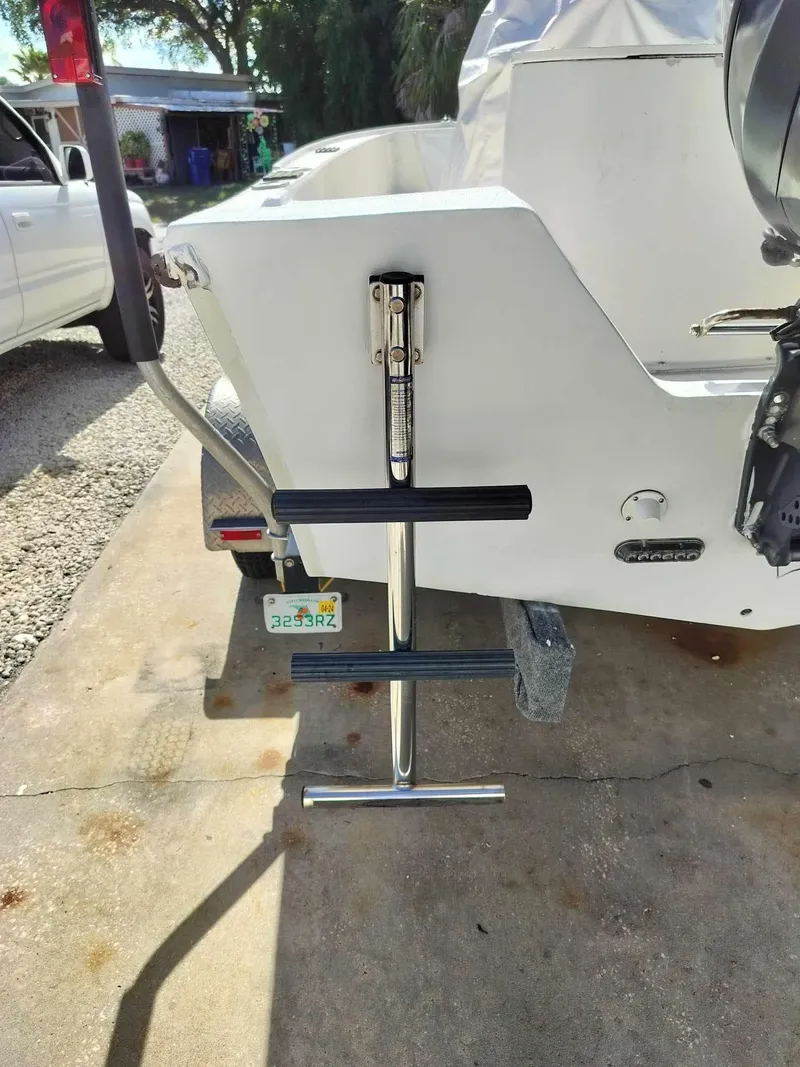 Slide: The Image of 1988 Mako 171 Center Console boat with a foldable ladder on the trailer. - 34